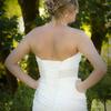 brides hairstyle compliments the back of the wedding gowns sweeping lines. 