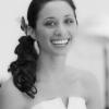 Bride hairstyle swept back from the face into a glamour side ponytail accented with a butterfly hair accessory.